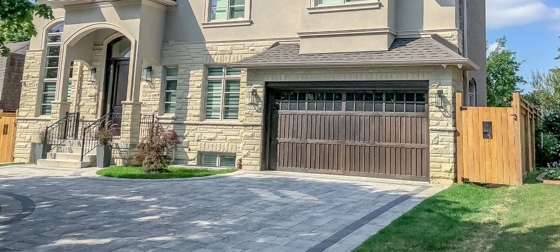 Residential home with a custom interlock paver driveway and walkway